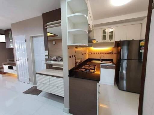 Modern kitchen with black countertop and white cabinets