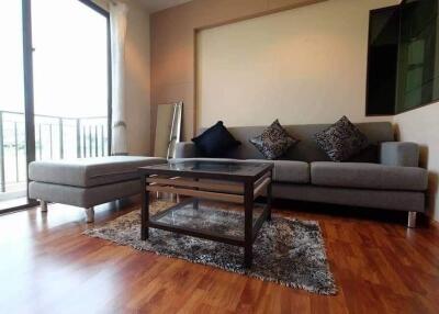 Modern living room with a gray sofa and glass coffee table