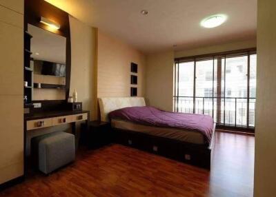 Modern bedroom with large windows and wooden flooring