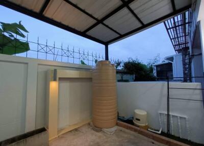 Covered outdoor area with water tank and enclosed space