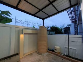 Covered outdoor area with water tank and enclosed space