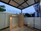 Covered outdoor area with water tank and enclosed space