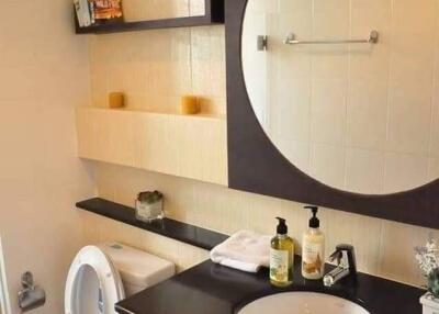 Modern bathroom with sink, mirror, and toilet