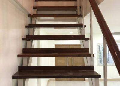 Modern wooden staircase with glass railings