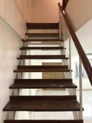 Modern wooden staircase with glass railings