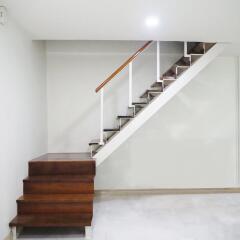 Modern staircase with wooden steps and white railing