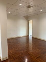 Spacious living room with wooden parquet flooring and recessed lighting