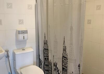 Bathroom with toilet and shower curtain