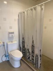 Bathroom with toilet and shower curtain