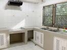 Modern kitchen with white tiled backsplash and dual sinks