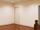 Empty room with wooden floor and white walls