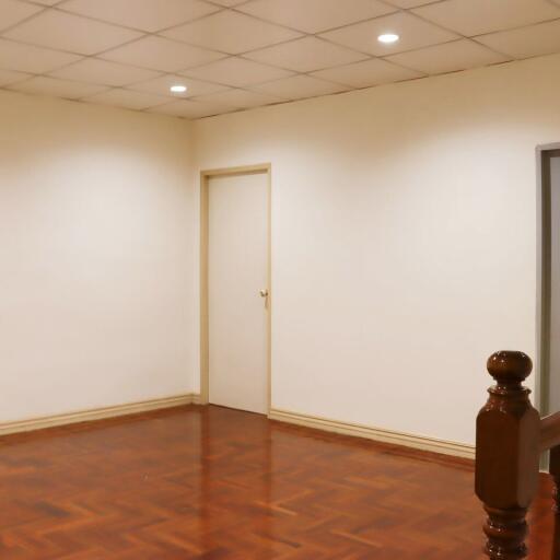 Empty room with wooden floor and white walls