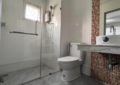 Modern bathroom with glass shower and tiled backsplash