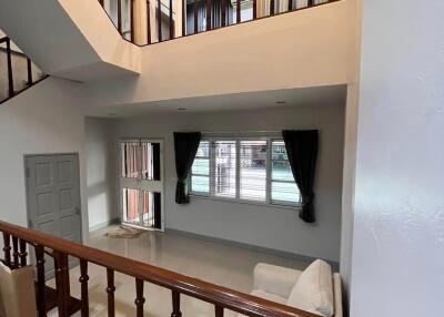 Spacious living room with high ceiling and large windows