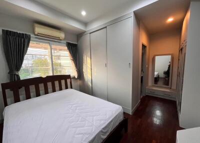 Bedroom with a wooden bed frame and ample closet space