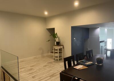 Minimalist dining area with table and plant