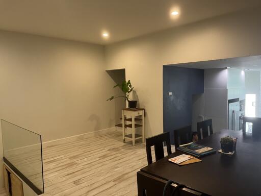 Minimalist dining area with table and plant