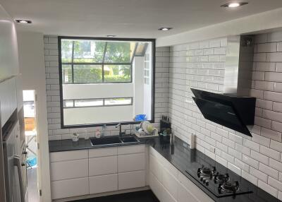 Modern kitchen with black countertops and white cabinets