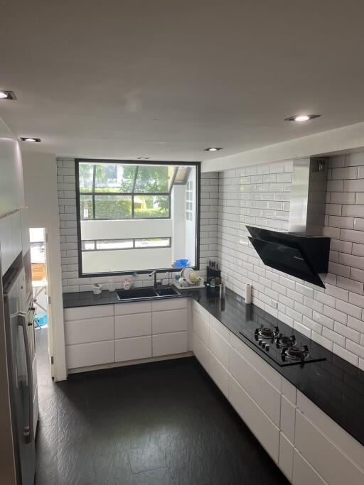 Modern kitchen with black countertops and white cabinets