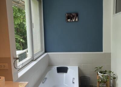 Spacious bathroom with a bathtub and large window