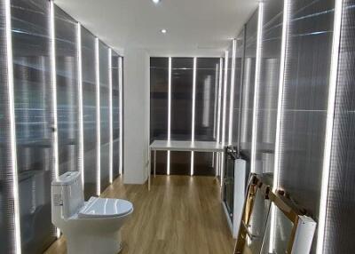 Modern bathroom with unique lighting and wooden flooring