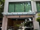 front entrance of a modern building with glass doors and large windows