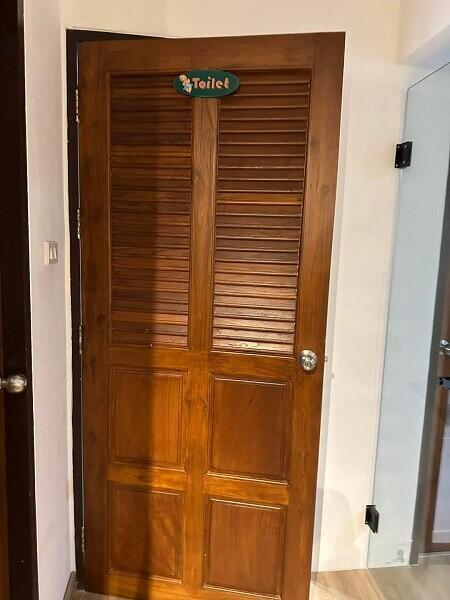 wooden door leading to a toilet