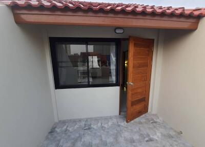 Entrance area with wooden door and window