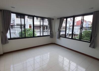 Bright bedroom with large windows and tiled floors