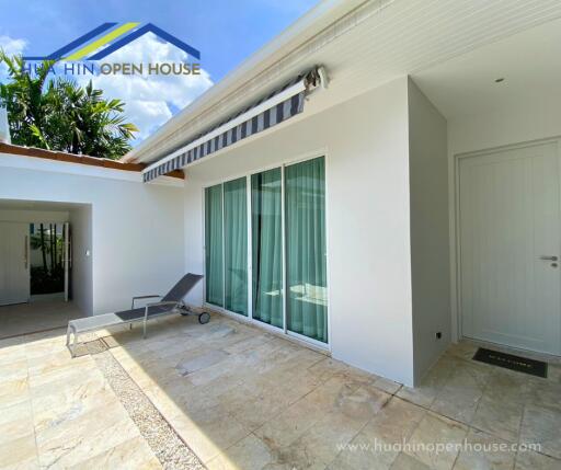 Outdoor area with lounge chair and sliding glass doors