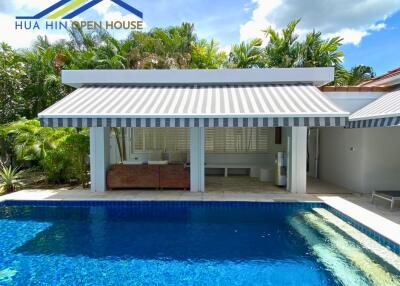 Modern backyard patio with pool and awning