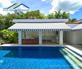 Modern backyard patio with pool and awning