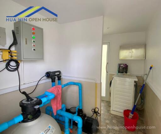 Utility room with water filtration system and washing machine