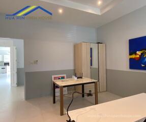 A living space with a table and storage wardrobe at Hua Hin Open House