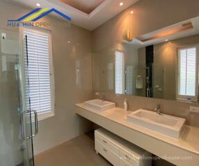 Modern bathroom with double sinks and large mirror