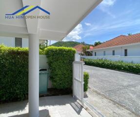 View from front door with lush greenery and neighboring houses