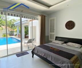 Bedroom with poolside view and modern design