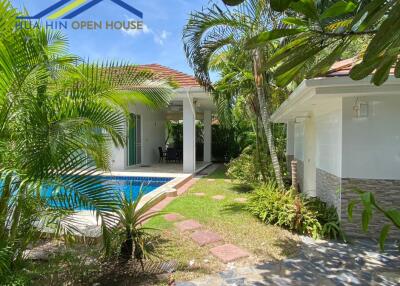 Outdoor view of a house with a pool and garden