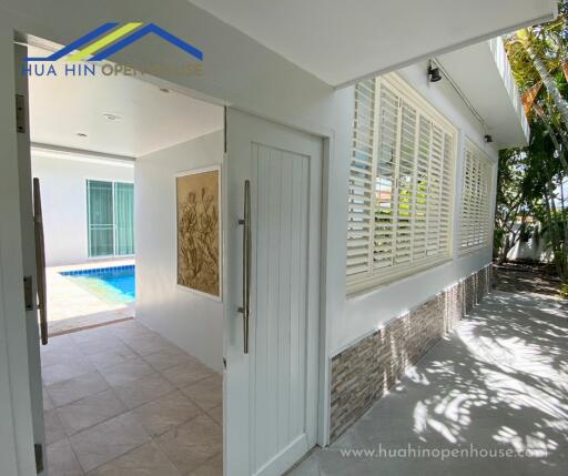 entrance to a house with pool view and patio