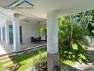 Covered patio with dining area and garden view