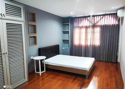 Modern bedroom with wooden floor and natural light