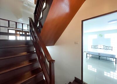 Staircase leading to a bright room