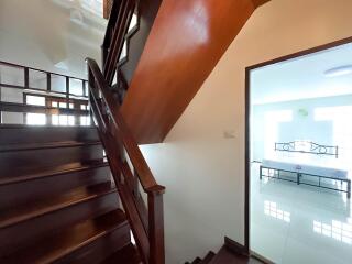 Staircase leading to a bright room