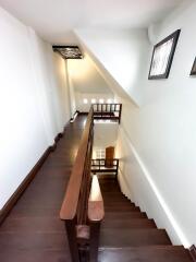 Interior staircase with wooden steps and railing