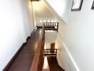 Interior staircase with wooden steps and railing