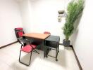 Small office space with a desk, chair, and plant