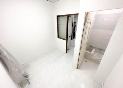 Small bathroom adjacent to a hallway or another room