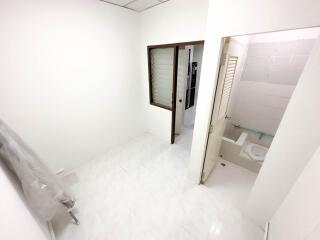 Small bathroom adjacent to a hallway or another room