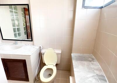 Modern bathroom with sink, toilet, and shower area