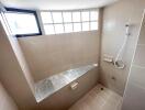 Modern tiled bathroom with shower and window lighting